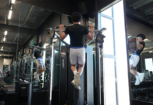 Person performing pull-ups in a gym