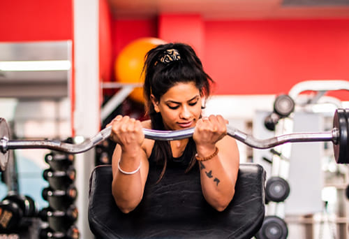 Person lifting a barbell in a gym
