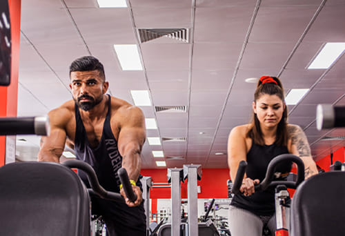 People exercising on stationary bikes in a gym